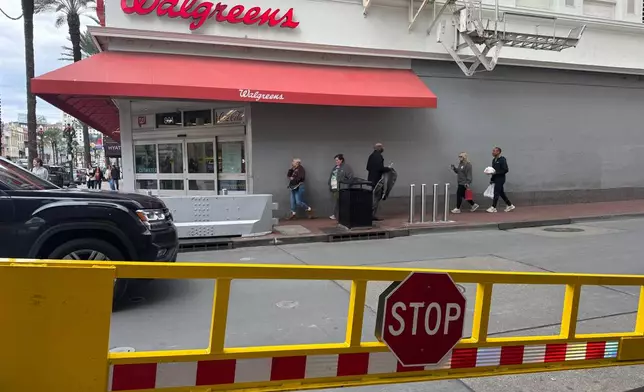 An opened gate is seen at the Bourbon Street corner in New Orleans on Monday, Dec. 29, 2025, the site of a Jan. 1, 2025, fatal vehicle ramming attack which led the city to bolster its safety measures in the area. (AP Photo/Jack Brook)