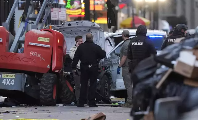 FILE - Emergency personnel work at the scene on Bourbon Street after a vehicle drove into a crowd on New Orleans' Canal and Bourbon Street, Wednesday Jan. 1, 2025. (AP Photo/Gerald Herbert, File)