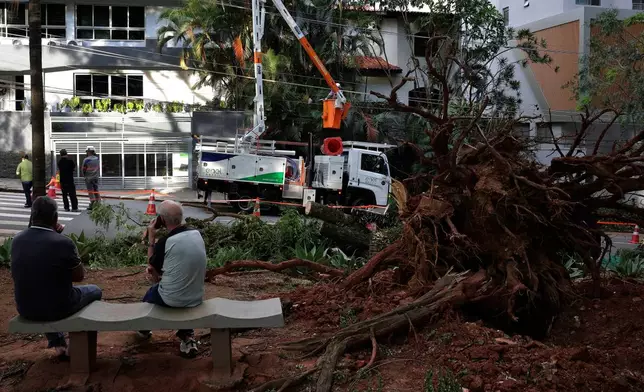 Workers attempt to restore power to Sao Paulo during a blackout on Thursday, Dec. 11, 2025. (AP Photo/Ettore Chiereguini)