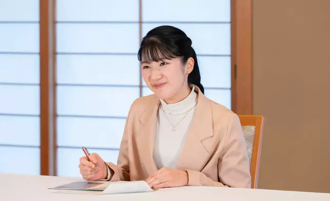 In this photo provided by the Imperial Household Agency of Japan, Princess Aiko, the daughter of Japan's Emperor Naruhito and Empress Masako, poses for a photo at the Imperial Palace in Tokyo, Monday, Nov. 10, 2025. (Imperial Household Agency of Japan via AP)
