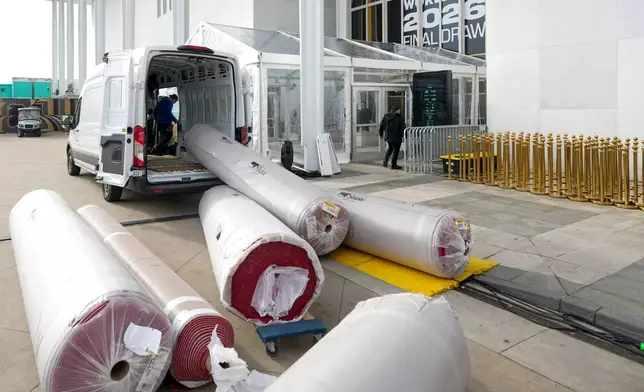 The red carpet is delivered prior to the final draw for the 2026 soccer World Cup at the Kennedy Center in Washington, Thursday, Dec. 4, 2025. (AP Photo/Chris Carlson)