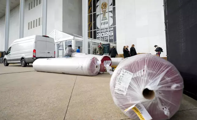 The red carpet is delivered prior to the final draw for the 2026 soccer World Cup at the Kennedy Center in Washington, Thursday, Dec. 4, 2025. (AP Photo/Chris Carlson)