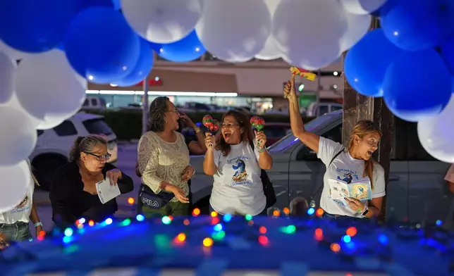 Nicaraguans sing in praise of the Virgin Mary at one of dozens of open-air altars set up near St. John Bosco Catholic Church in celebration of the Dec. 8 feast of the Immaculate Conception, Sunday, Dec. 7, 2025, in Miami. (AP Photo/Rebecca Blackwell)