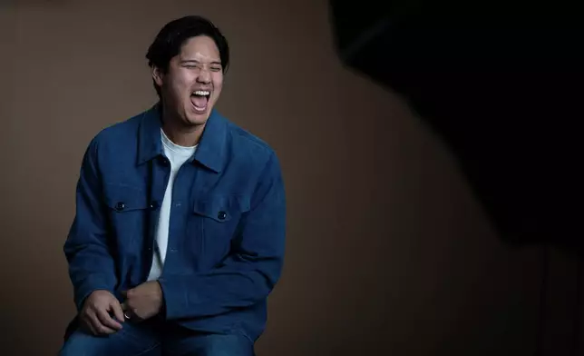 Los Angeles Dodgers' Shohei Ohtani shares a laugh with his translator during an interview with The Associated Press in Pasadena, Calif., Wednesday, Nov. 26, 2025. (AP Photo/Jae C. Hong)