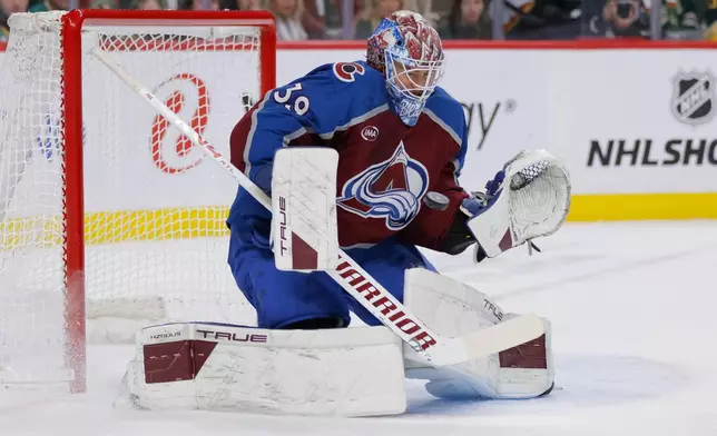 Colorado Avalanche goaltender Mackenzie Blackwood makes a save during the first period of an NHL hockey game against the Minnesota Wild, Sunday, Dec. 21, 2025, in St. Paul, Minn. (AP Photo/Bailey Hillesheim)