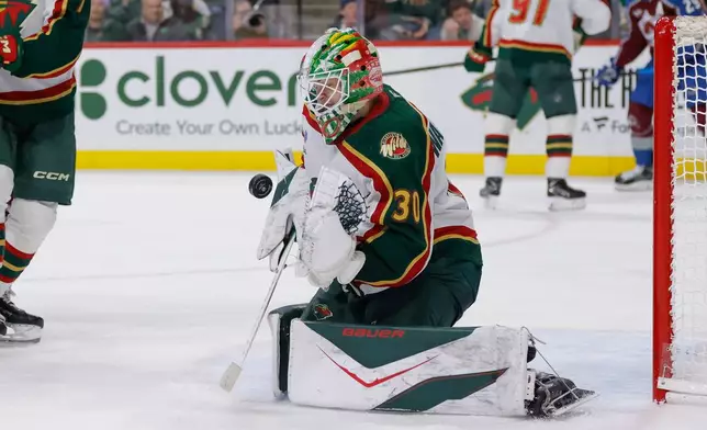 Minnesota Wild goaltender Jesper Wallstedt (30) makes a save during the second period of an NHL hockey game against the Colorado Avalanche, Sunday, Dec. 21, 2025, in St. Paul, Minn. (AP Photo/Bailey Hillesheim)