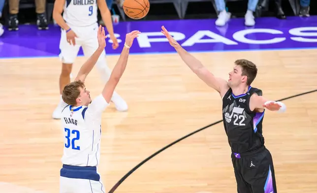 Dallas Mavericks forward Cooper Flagg (32) shoots over Utah Jazz forward Kyle Filipowski (22) during the first half of an NBA basketball game, Monday, Dec. 15, 2025, in Salt Lake City. (AP Photo/Tyler Tate)