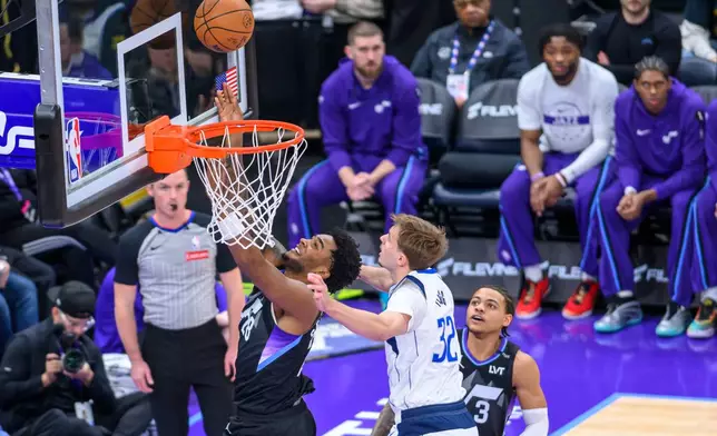 Utah Jazz forward Brice Sensabaugh (28) plays the ball off the glass while guarded by Dallas Mavericks forward Cooper Flagg (32) during the first half of an NBA basketball game, Monday, Dec. 15, 2025, in Salt Lake City. (AP Photo/Tyler Tate)