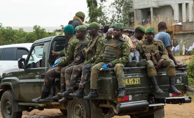 Soldiers patrol as thousands of people fleeing fighting in Congo's South Kivu province arrive in Cibitoke, Kansega, Burundi, Thursday, Dec. 11, 2025. (AP Photo/Berthier Mugiraneza)