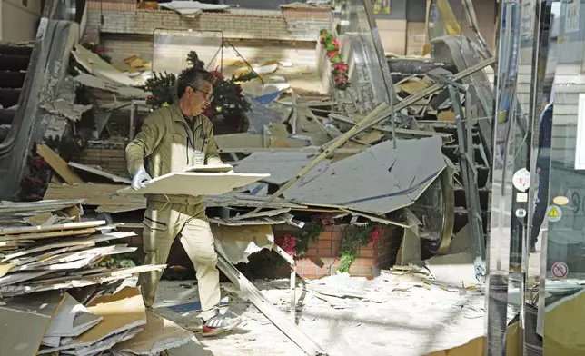 A man clears the debris from a powerful earthquake at a commercial facility in Hachinohe, Aomori prefecture, northern Japan Tuesday, Dec. 9, 2025. (Ren Onuma/Kyodo News via AP)