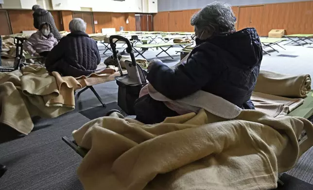Evacuees get ready to return home as a tsunami advosory has been lifted in Hidaka town, northern Japan Tuesday, Dec. 9, 2025, following a powerful earthquake on late Monday. (Kyodo News via AP)