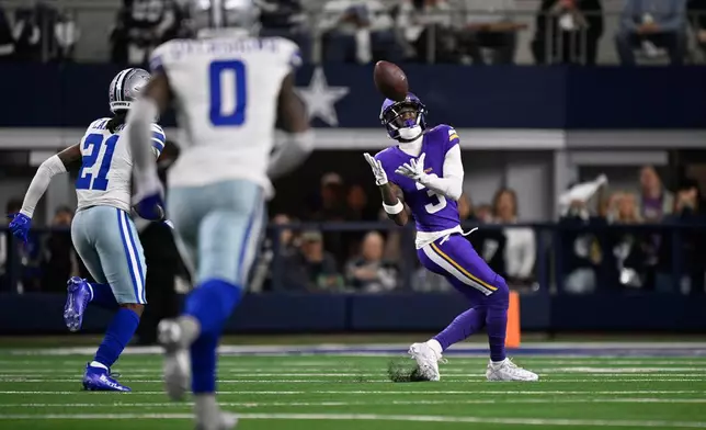 Minnesota Vikings wide receiver Jordan Addison makes a catch during the first half of an NFL football game against the Dallas Cowboys Sunday, Dec. 14, 2025, in Arlington, Texas. (AP Photo/Jerome Miron)