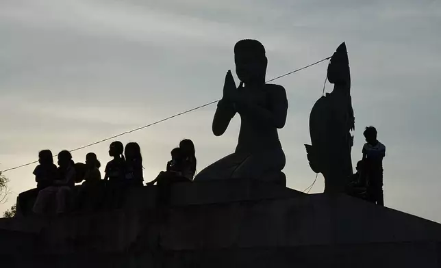 Children take refuge in Srey Snam, Siem Reap province after fleeing with their families from their homes at Cambodia's border with Thailand, Tuesday, Dec. 9, 2025. (AP Photo/Heng Sinith)