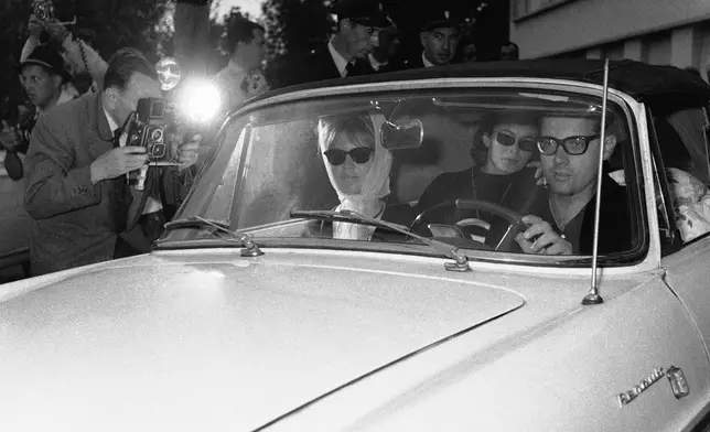 FILE - Brigitte Bardot is driven from the St. Francois neurological clinic, Oct. 3, 1960 by press representative Michel Simon. (AP Photo/File)