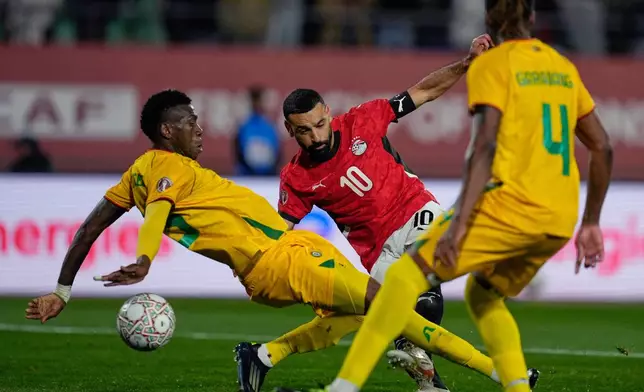 Egypt's Mohamed Salah scores during the Africa Cup of Nations group B soccer match between Egypt and Zimbabwe in Agadir, Morocco, Monday, Dec. 22, 2025. (AP Photo/Mosa'ab Elshamy)