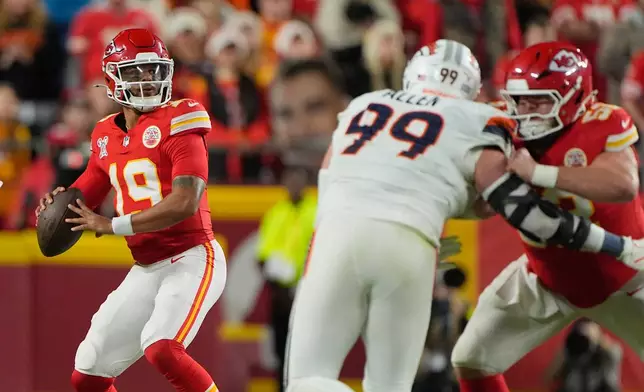 Kansas City Chiefs quarterback Chris Oladokun (19) looks to pass as teammate center Creed Humphrey, right, blocks Denver Broncos defensive end Zach Allen (99) during the first half of an NFL football game Thursday, Dec. 25, 2025, in Kansas City, Mo. (AP Photo/Charlie Riedel)