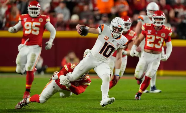 Denver Broncos quarterback Bo Nix (10) is tackled by Kansas City Chiefs defensive end George Karlaftis (56) during the first half of an NFL football game Thursday, Dec. 25, 2025, in Kansas City, Mo. (AP Photo/Charlie Riedel)