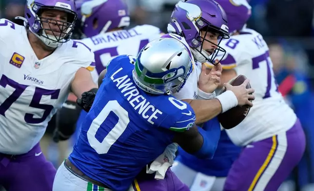 Seattle Seahawks defensive end DeMarcus Lawrence (0) sacks Minnesota Vikings quarterback Max Brosmer during the first half of an NFL football game, Sunday, Nov. 30, 2025, in Seattle. (AP Photo/Stephen Brashear)