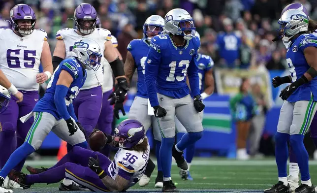Seattle Seahawks linebacker Ernest Jones IV (13) reacts after tackling Minnesota Vikings running back Zavier Scott (36) during the second half of an NFL football game, Sunday, Nov. 30, 2025, in Seattle. (AP Photo/Lindsey Wasson)