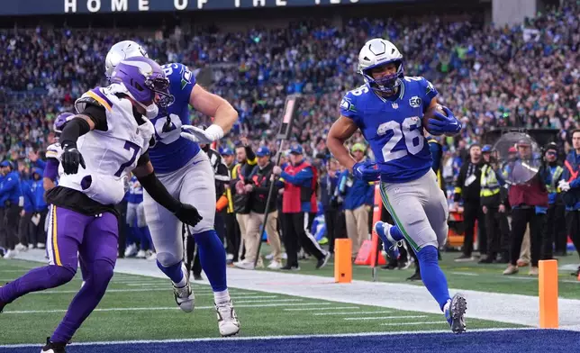 Seattle Seahawks running back Zach Charbonnet (26) runs for a touchdown against the Minnesota Vikings during the second half of an NFL football game, Sunday, Nov. 30, 2025, in Seattle. (AP Photo/Lindsey Wasson)