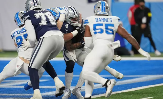Dallas Cowboys quarterback Dak Prescott (4) is sacked by Detroit Lions linebacker Jack Campbell, not visible, during the first half of an NFL football game Thursday, Dec. 4, 2025, in Detroit. (AP Photo/Paul Sancya)
