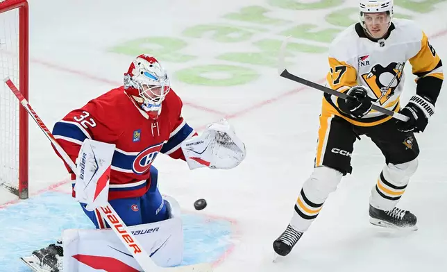 Pittsburgh Penguins' Rickard Rakell (67) moves in on Montreal Canadiens goaltender Jacob Fowler (32) during the second period of an NHL hockey game, in Montreal, Saturday, Dec. 20, 2025. (Graham Hughes/The Canadian Press via AP)