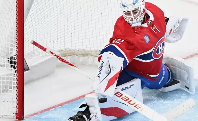 Montreal Canadiens goaltender Jacob Fowler makes a save against the Pittsburgh Penguins during the second period of an NHL hockey game, in Montreal, Saturday, Dec. 20, 2025. (Graham Hughes/The Canadian Press via AP)