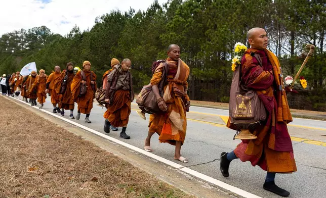 Buddhist monks on a "Walk for Peace" walk on Veterans Parkway in Fayetteville, Ga., on Monday, Dec. 29, 2025, from Texas to Washington, D.C. (Arvin Temkar/Atlanta Journal-Constitution via AP)