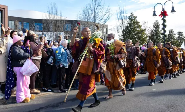 Buddhist monks on a "Walk for Peace" walk through Trilith in Fayetteville, Ga., on Monday, Dec. 29, 2025, from Texas to Washington, D.C. (Arvin Temkar/Atlanta Journal-Constitution via AP)