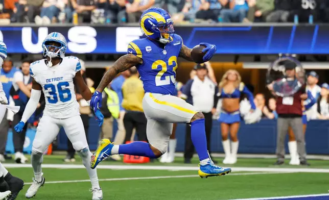 Los Angeles Rams running back Kyren Williams (23) scores a rushing touchdown during the first half of an NFL football game against the Detroit Lions, Sunday, Dec. 14, 2025, in Inglewood, Calif. (AP Photo/Caroline Brehman)