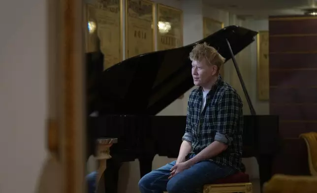 Stage director Vasily Barkhatov sits during an interview with The Associated Press prior to the dressed rehearsal of Dmitri Shostakovich's Lady Macbeth of the Mtsensk District at La Scala Opera House in Milan, Italy, Thursday, Dec. 4, 2025. (AP Photo/Antonio Calanni)