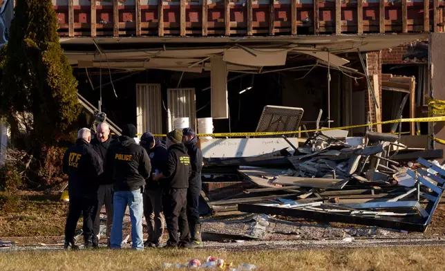 Investigators work around Bristol Health &amp; Rehab Center and surrounding rubble after a gas explosion the day prior on Wednesday, Dec. 24, 2025, in Bristol, Pa. (AP Photo/Mingson Lau)