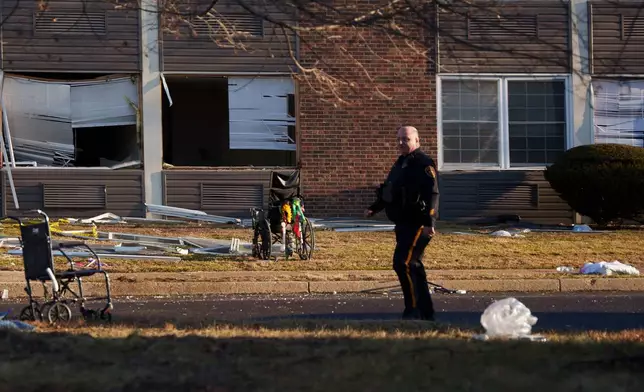 A responder navigates around Bristol Health &amp; Rehab Center and surrounding rubble after a gas explosion the day prior on Wednesday, Dec. 24, 2025, in Bristol, Pa. (AP Photo/Mingson Lau)