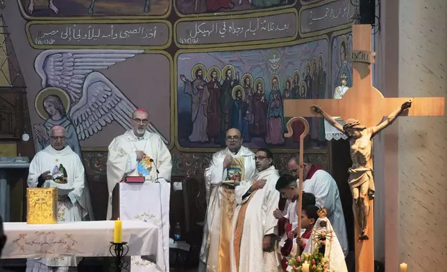 Cardinal Pierbattista Pizzaballa, the Latin Patriarch of Jerusalem, second left, leads a mass ahead og Christmass celebrations at the Holy Family Catholic Church in Gaza City, Sunday, Dec. 21, 2025. (AP Photo/Jehad Alshrafi)