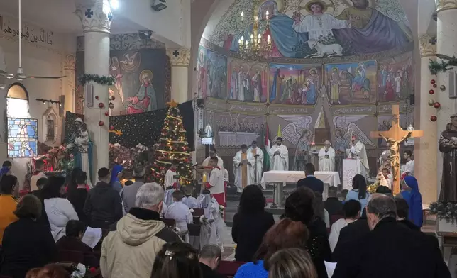 Palestinians parishioners attend a mass led by Cardinal Pierbattista Pizzaballa, the Latin Patriarch of Jerusalem, ahead of Christmas celebrations in Gaza City, Sunday, Dec. 21, 2025. (AP Photo/Jehad Alshrafi)