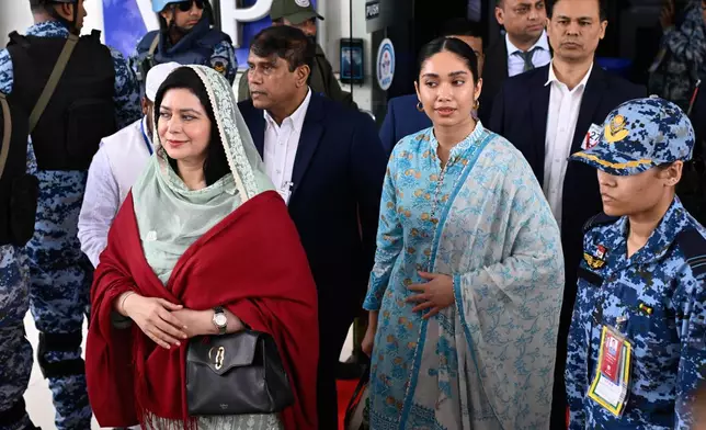 Bangladesh Nationalist Party (BNP) Acting Chairman Tarique Rahman's wife, Zubaida Rahman, left, arrives with her daughter Zaima Rahman at Hazrat Shahjalal International Airport in Dhaka, Bangladesh, as they return to the country, Thursday, Dec. 25, 2025. (AP Photo/Mahmud Hossain Opu)
