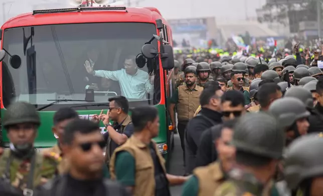 Bangladesh Nationalist Party (BNP) Acting Chairman Tarique Rahman waves to supporters from a bus in Dhaka after returning from London, ending more than 17 years of self-imposed exile, Thursday, Dec. 25, 2025.(AP Photo/Mahmud Hossain Opu)