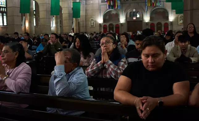 FILE - Parishioners pray during a Sunday Mass at the Shrine of the Sacred Heart Catholic church in Washington, Oct. 12, 2025. (AP Photo/Luis Andres Henao, File)