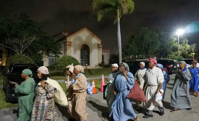 FILE - Parishioners of Notre Dame d'Haiti process outside the Catholic church during a Lent faith event that reenacted the biblical story of the Red Sea passage March 29, 2025, in Miami. (AP Photo/Giovanna Dell'Orto, File)