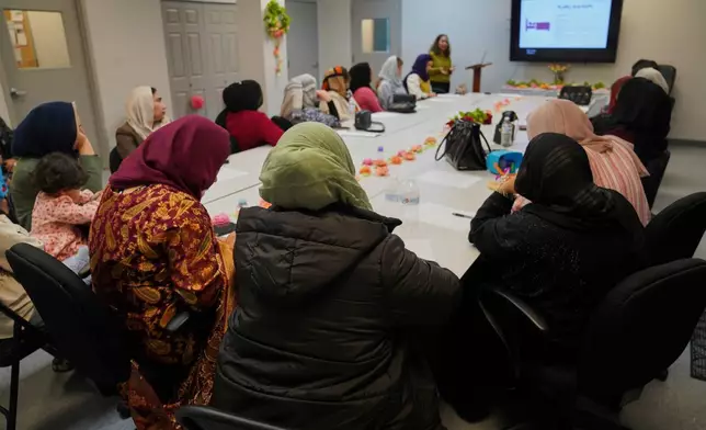 FILE - A group of female Afghan refugees gather for a class on self-care and a post-Ramadan celebration at Catholic Charities Migrant and Refugee Services office in Fredericksburg, Va., on Tuesday, April 8, 2025. (AP Photo/Jessie Wardarski, File)