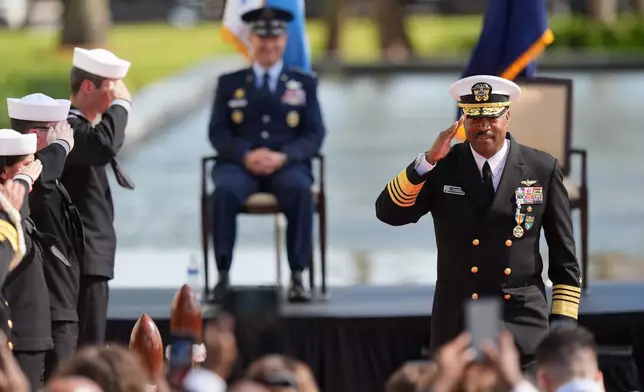 Navy Adm. Alvin Holsey salutes as Gen. Dan Caine, chairman of the Joint Chiefs of Staff, watches from stage during a relinquishment of command and retirement ceremony at U.S. Southern Command (SOUTHCOM), Friday, Dec. 12, 2025, in Doral, Fla. (AP Photo/Rebecca Blackwell)