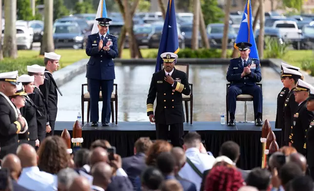 Navy Adm. Alvin Holsey, center, leaves the stage as Gen. Dan Caine, left, chairman of the Joint Chiefs of Staff, and Air Force Lt. Gen. Evan Pettus, taking over command, applaud during Holsey's relinquishment of command and retirement ceremony, at U.S. Southern Command (SOUTHCOM), Friday, Dec. 12, 2025, in Doral, Fla. (AP Photo/Rebecca Blackwell)