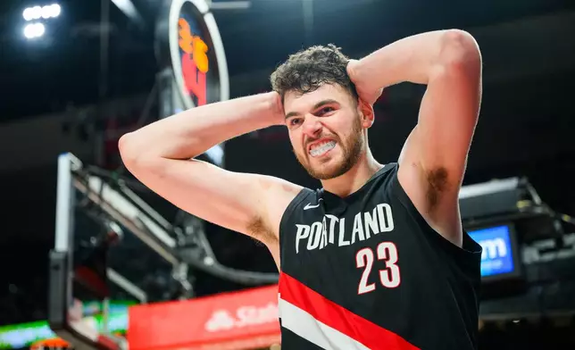Portland Trail Blazers center Donovan Clingan (23) reacts after being fouled during the second half of an NBA basketball game against the Detroit Pistons, Monday, Dec. 22, 2025, in Portland, Ore. (AP Photo/Molly J. Smith)