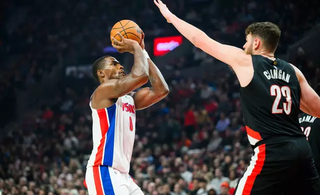 Detroit Pistons center Jalen Duren (0) looks to shoot past Portland Trail Blazers center Donovan Clingan (23) during the first half of an NBA basketball game, Monday, Dec. 22, 2025, in Portland, Ore. (AP Photo/Molly J. Smith)