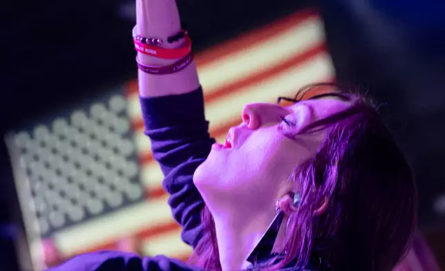 An attendee prays during Faith Night worship events at Turning Point USA's AmericaFest 2025, Saturday, Dec. 20, 2025, in Phoenix. (AP Photo/Jon Cherry)