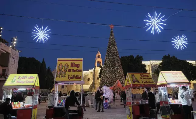 Palestinian vendors wait for clients in Manger Square in the West Bank city of Bethlehem, Tuesday, Dec. 16, 2025. (AP Photo/Mahmoud Illean)