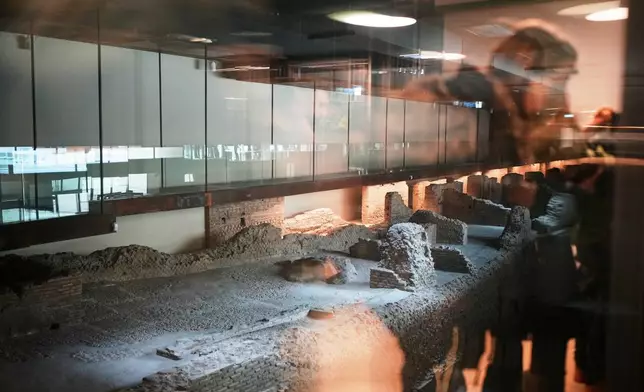 A view of the remains of Roman barracks built around the 2nd century AD under the emperor Trajan, visible in the Porta Metronia new subway station designed as a museum to showcase the archaeological finds uncovered during its construction, in Rome, Tuesday, Dec. 16, 2025. (AP Photo/Alessandra Tarantino)