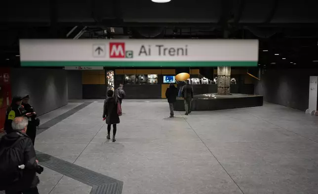 People walk in the hall of the 'Colosseo' new subway station in Rome, Tuesday, Dec. 16, 2025. (AP Photo/Alessandra Tarantino)