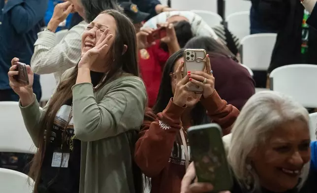 People celebrate after passage of the National Defense Authorization Act by the U.S. Senate, during a watch party hosted by the Lumbee Tribe of North Carolina, Wednesday, Dec. 17, 2025, in Pembroke, N.C. (AP Photo/Allison Joyce)