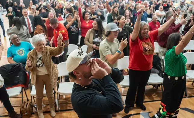 People celebrate after passage of the National Defense Authorization Act by the U.S. Senate during a watch party hosted by the Lumbee Tribe of North Carolina, Wednesday, Dec. 17, 2025, in Pembroke, N.C. (AP Photo/Allison Joyce)